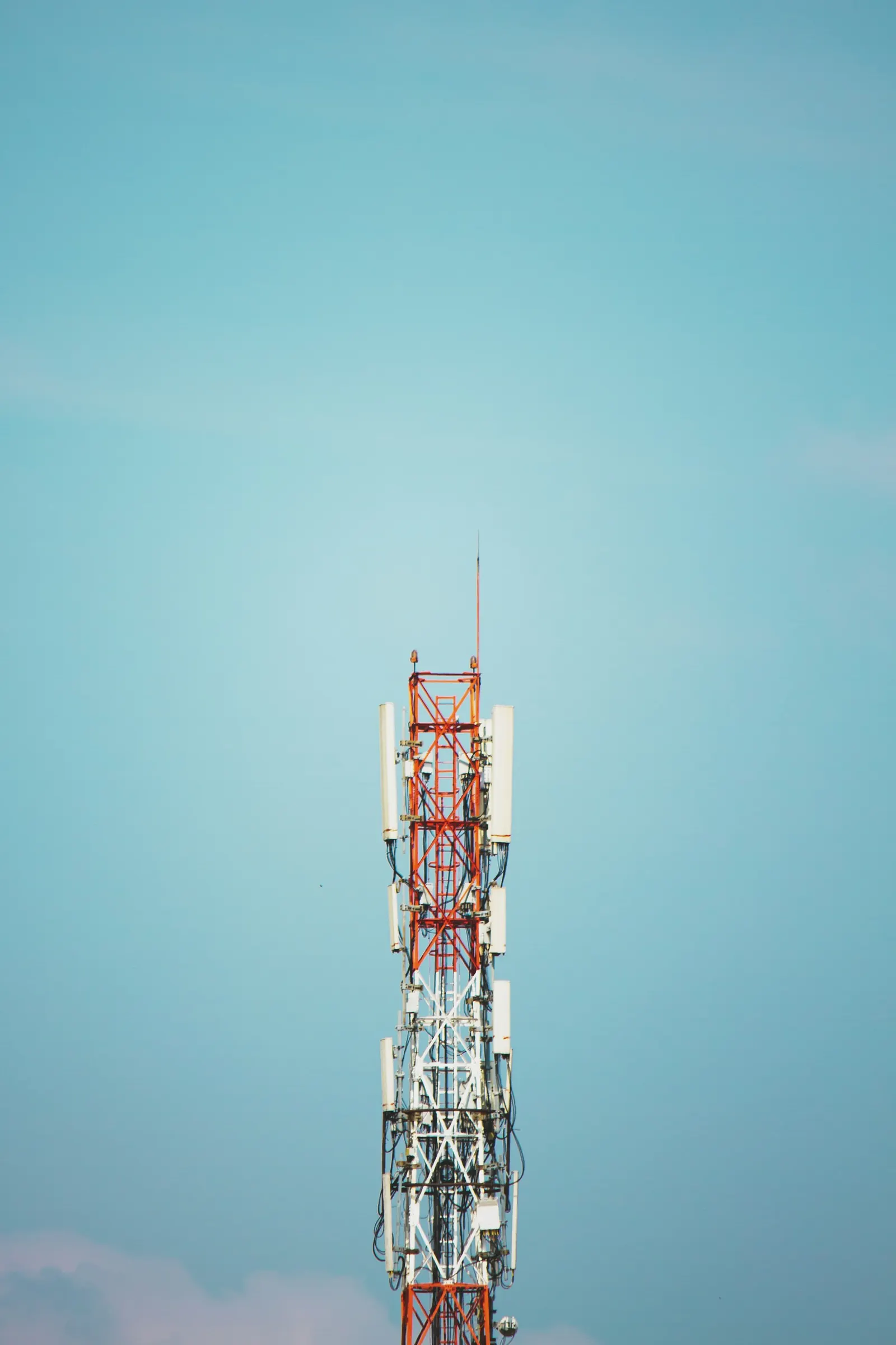 Telecommunication tower against a clear blue sky in Jakarta